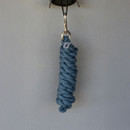 Handmade blue cotton rope keychain with a braided design hangs from a brass hook against a light grey wall, conveying simplicity and craftsmanship.