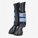 Pair of black equine leg boots with light blue straps branded "LeMieux," displayed on black model legs against a plain white background.