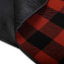 Close-up of red and black check fabric with black waterproof underside.