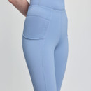 A close-up of a person wearing light blue, fitted athletic leggings with a subtle logo. The smooth fabric and sleek design convey a sporty, modern feel.