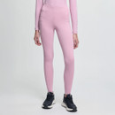 A person in pink athletic leggings and a matching long-sleeve top stands against a plain white background, wearing black and white sneakers.