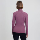 Rear view of a person wearing a purple long-sleeve athletic top and black leggings. The pose is neutral, highlighting the outfit’s fit and seams.