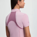 Young woman shown from behind, wearing a fitted pink athletic shirt with textured fabric and darker pink panels. Her hair is straight and smooth.