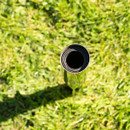 Top view of a metal rotary washing line ground spike installed in a lawn, showing the black inner sleeve inside the tube.