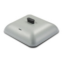 Square, light grey metal lid with rounded corners and a matte finish, featuring a small black handle centered on top and a narrow steam vent slot near one edge, shown against a plain light background.