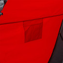 Interior close-up of red tent wall with attached storage pocket.