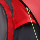 Close-up of red tent fabric and stitched seams with covered side ventilation panel and green guy line.