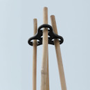 Close-up of the plant support clip securing three bamboo canes at the top of the Plant Halo system.