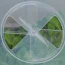 Close-up of the adjustable circular ventilation vent on top of the clear square cloche cover.