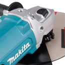 Close-up of a blue and silver Makita angle grinder showing part of the blade and handle.
