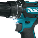Close up of Makita cordless drill driver LED light illuminating drilling area.