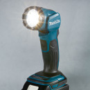 The Makita cordless LED flashlight is illuminated with a bright beam.