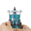 The user is adjusting the Makita cordless router depth control.