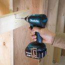 User driving screw with Makita brushless impact driver.