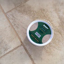 Azpects Easy Patio Joint Repair grey beige compound lid placed on outdoor paving slabs showing product colour and finish