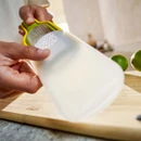 Protective sheath being fitted over the grater for safe storage.