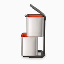 Side view of the bin on its stand with upper lid open and lower compartment accessible.