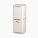 Closed stone-coloured compact dual waste and recycling bin with a sleek rectangular design and front handle.