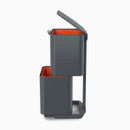 Side view of the compact two-tier bin system with both top and bottom compartments open, showing stacked waste and recycling sections.