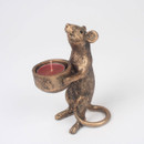 Front three-quarter view of the gold mouse candle holder with curled tail and red tealight in its hands.