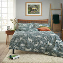 Green woodland animal duvet cover set on double bed, featuring deer, rabbits and botanical foliage print, modern bedroom styling with wooden bed frame, soft rug and decorative cushions