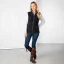 Full-length view of model wearing the navy fleece gilet with jeans and brown boots.