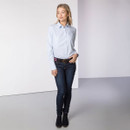 Full-length view of a woman wearing the light blue striped shirt with jeans, belt and ankle boots.