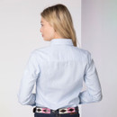 Back view of a woman wearing a light blue and white striped shirt with long sleeves and fitted shape.