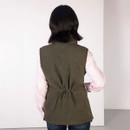 Back view of a woman wearing a khaki fleece gilet with an adjustable drawcord at the waist.