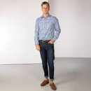 Full-length view of the model wearing the checked shirt with jeans and brown loafers for a smart-casual look.