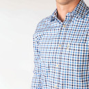 Close-up of the shirt showing the blue and white check pattern, button fastening and chest pocket detail.