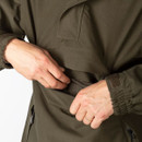 Close-up of the front chest flap pocket opened to reveal a zipped compartment and inner lining.