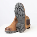Close-up of the boot sole showing deep tread pattern, grip design and branded outsole detail.