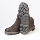 View of the boots highlighting the rugged rubber outsole with deep tread pattern for grip and durability.