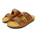 Pair of brown leather double-strap sandals with adjustable metal buckles and cork footbed