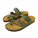 Pair of green strappy sandals with adjustable metal buckles and cork footbed