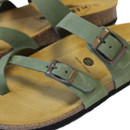 Close-up of green sandal straps with metal buckle detail and cushioned cork sole