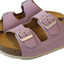 Close-up of pink suede sandal straps with metal buckle fastening and textured cork footbed