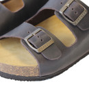 Close-up of dark brown leather sandal straps with metal buckle fastening and textured cork footbed