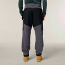 Rear view of grey and black work trousers with reinforced panels and functional back pockets, paired with tan work boots.