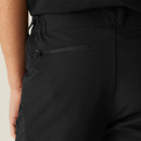 Close-up of black technical trousers showing articulated knee panels with textured stretch fabric for mobility