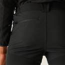 Close-up of black trousers showing zipped thigh pocket and textured stretch fabric