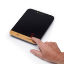 Hand pressing the touch control on a black digital kitchen scale with red LED display.