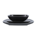 Matt black square bowl placed on matching square plates, shown from a low side angle.