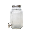 Angled side view of a clear ribbed glass drinks dispenser with metal lid and spout.