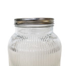 Close-up of the top of the glass dispenser showing the screw-on metal lid and ridged glass detail.