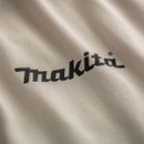 Close-up of beige t-shirt fabric with black Makita logo printed on chest