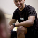 Close-up of person wearing black Makita t-shirt with chest logo visible, seated indoors