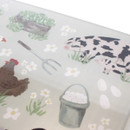 Close-up of the worktop saver showing a cow and calf, hen, pitchfork and bucket of eggs among floral details.