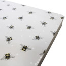 Close-up of the placemat surface highlighting the detailed bee pattern and smooth finish.